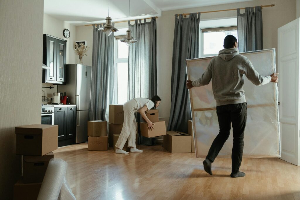 pexels-photo-4554230-4554230 A young couple unpacks boxes in their new apartment, arranging their belongings.